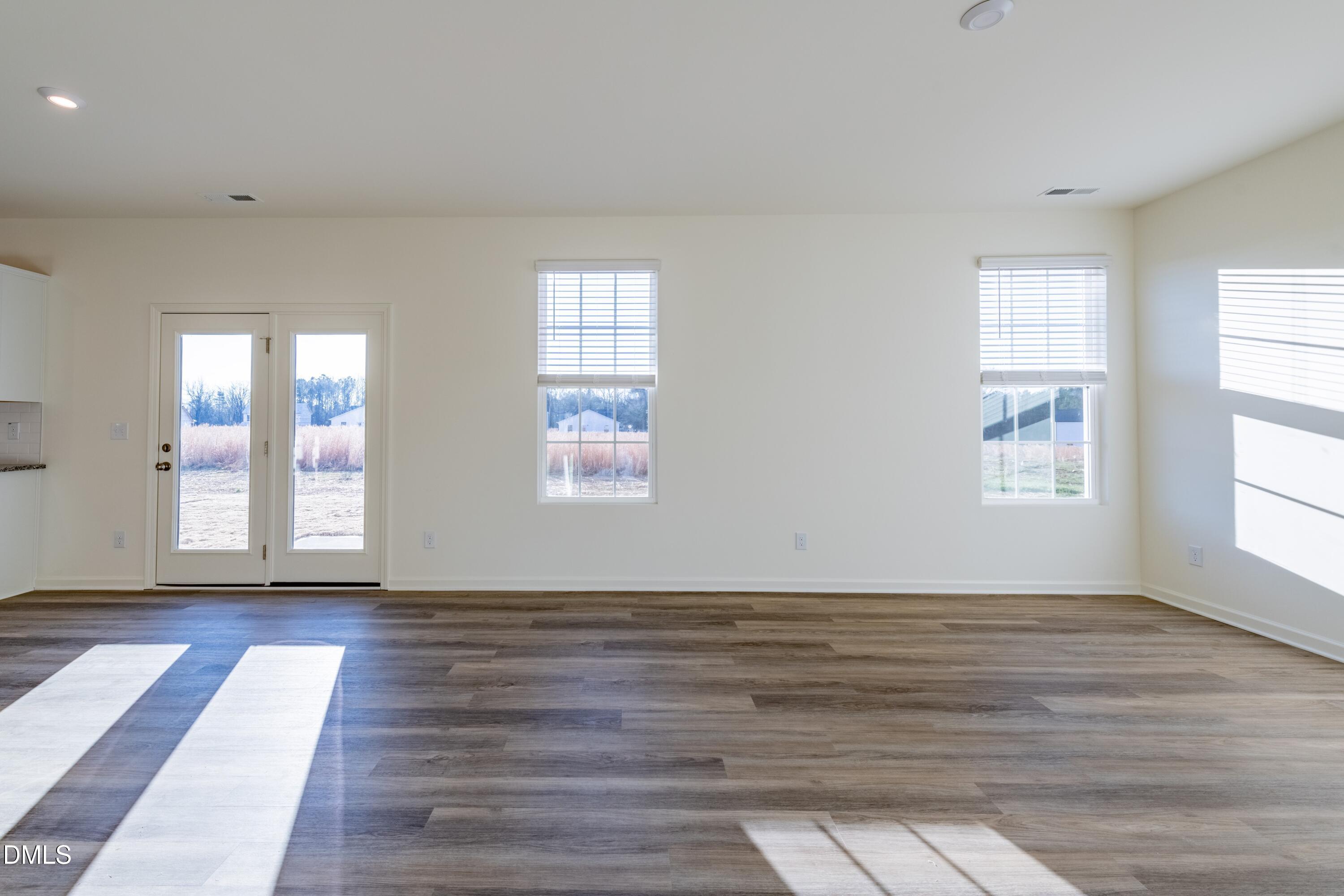 55 Fern Ridge Drive, Unit 1 Cameron, NC 28326 - Photo 7 of 42 a view of an empty room with wooden floor and a window