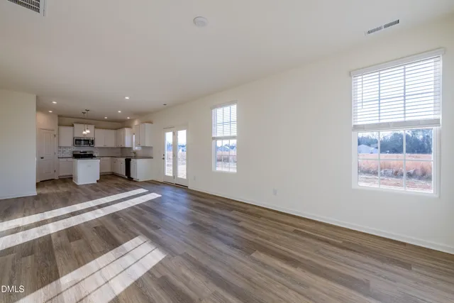 a view of kitchen and hall with wooden floor