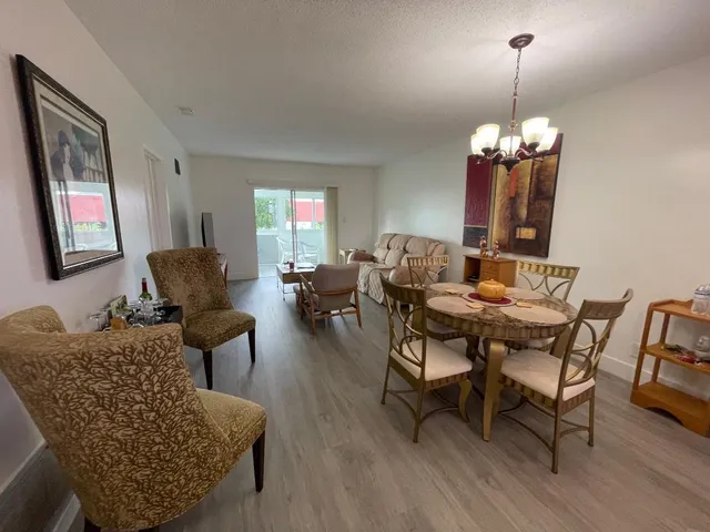 a living room with furniture chandelier and a window