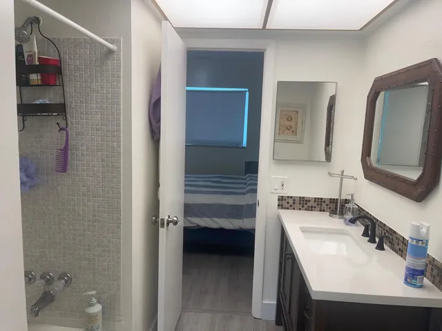 a bedroom with a bed and a painting on the wall