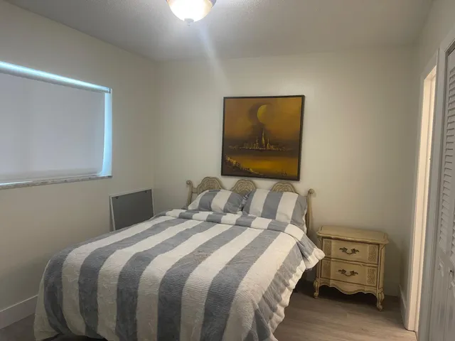 a bedroom with a bed and a view of bathroom