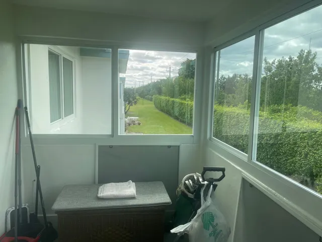 a view of a house with a small yard and a large window