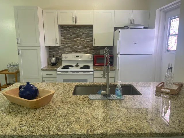 a kitchen with sink and refrigerator