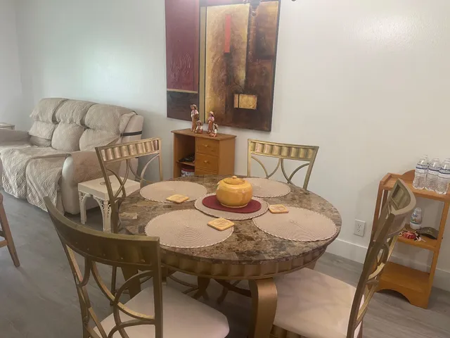 a living room with furniture and a painting on the wall