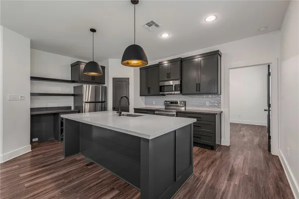 a kitchen with stainless steel appliances kitchen island a large island in the center