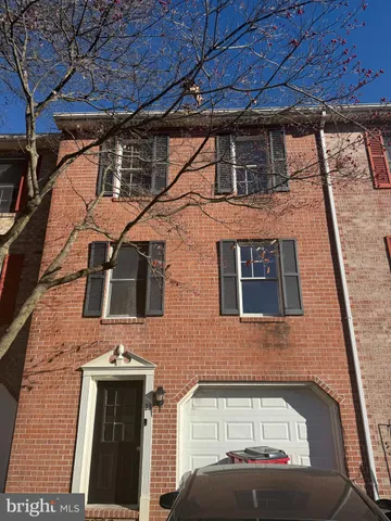 a front view of a house with a parking space