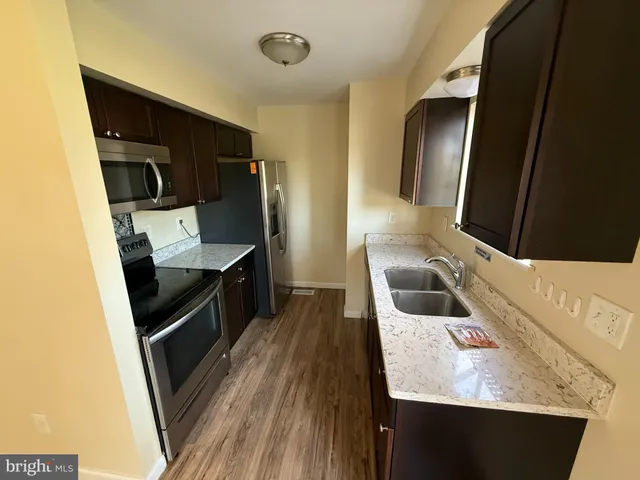 a kitchen with a sink stove and refrigerator