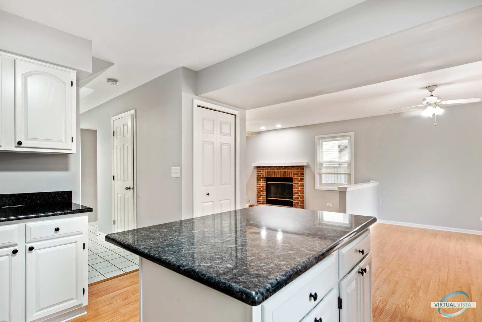 960 Millwood Drive Bartlett, IL 60103 - Photo 12 of 33 a kitchen with stainless steel appliances granite countertop a sink and white cabinets with wooden floor