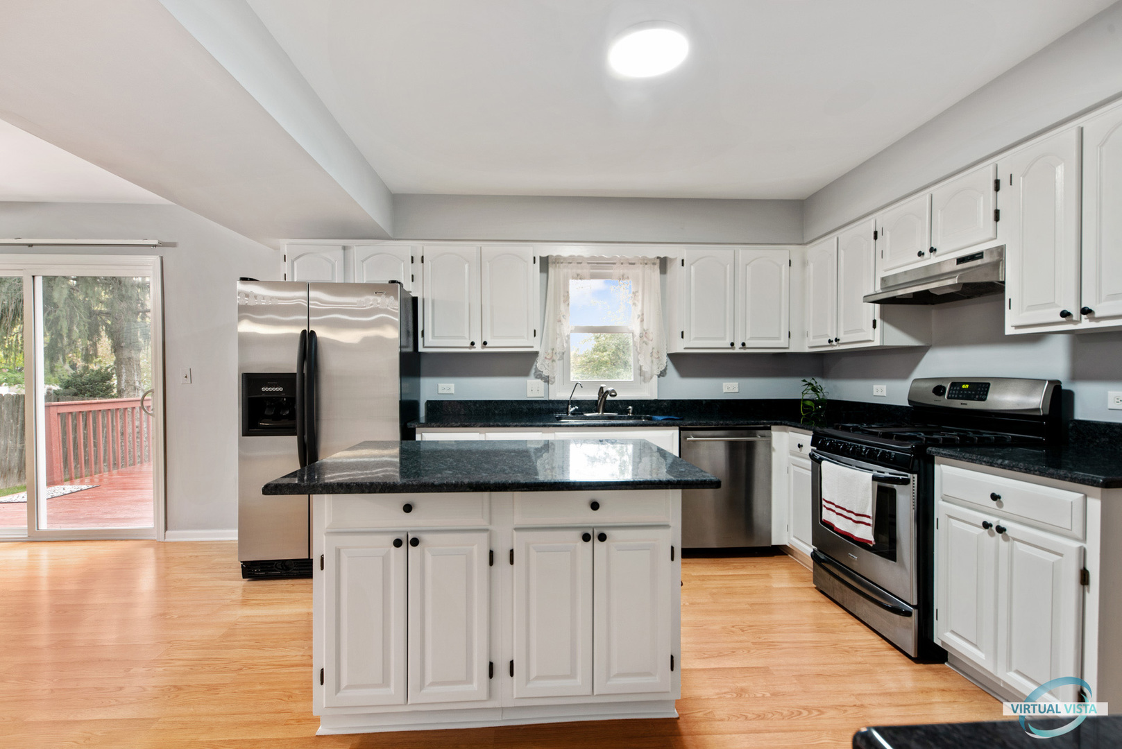 960 Millwood Drive Bartlett, IL 60103 - Photo 10 of 33 a kitchen with granite countertop a sink cabinets and stainless steel appliances