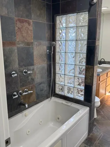 a bathroom with a bathtub and shower