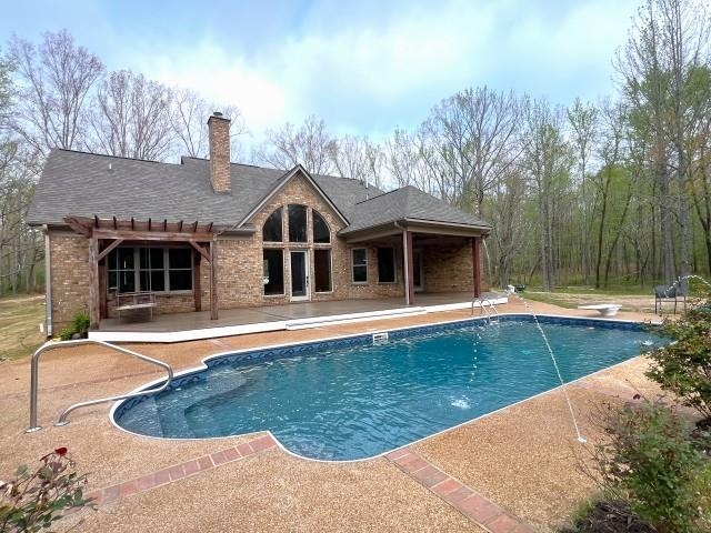 9490 Highway 196 Collierville, TN 38017 - Photo 39 of 40 Swimming pool with a patio area, a diving board, and a pergola