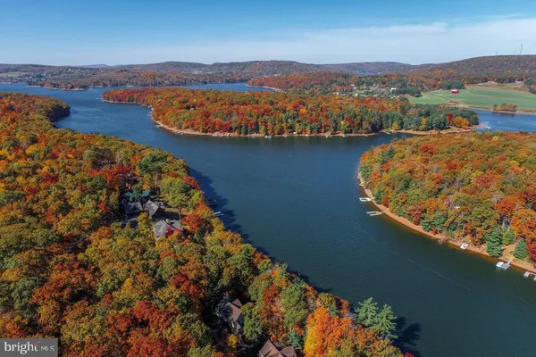 a view of a lake with houses in the back