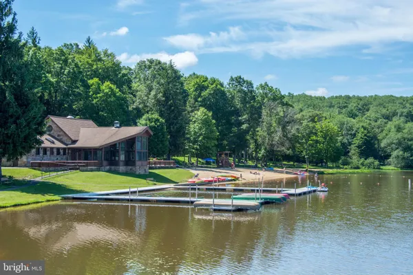 a view of lake with swimming pool and green space