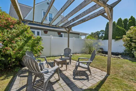 a view of backyard with outdoor seating and plants