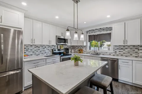 a kitchen with refrigerator cabinets and wooden floor