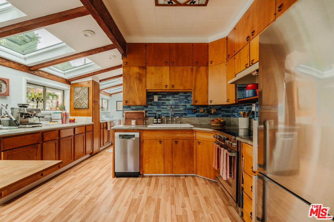 6457 Tokay Road Tujunga, CA 91042 - Photo 24 of 53 a kitchen with stainless steel appliances granite countertop a refrigerator a stove and a wooden floors