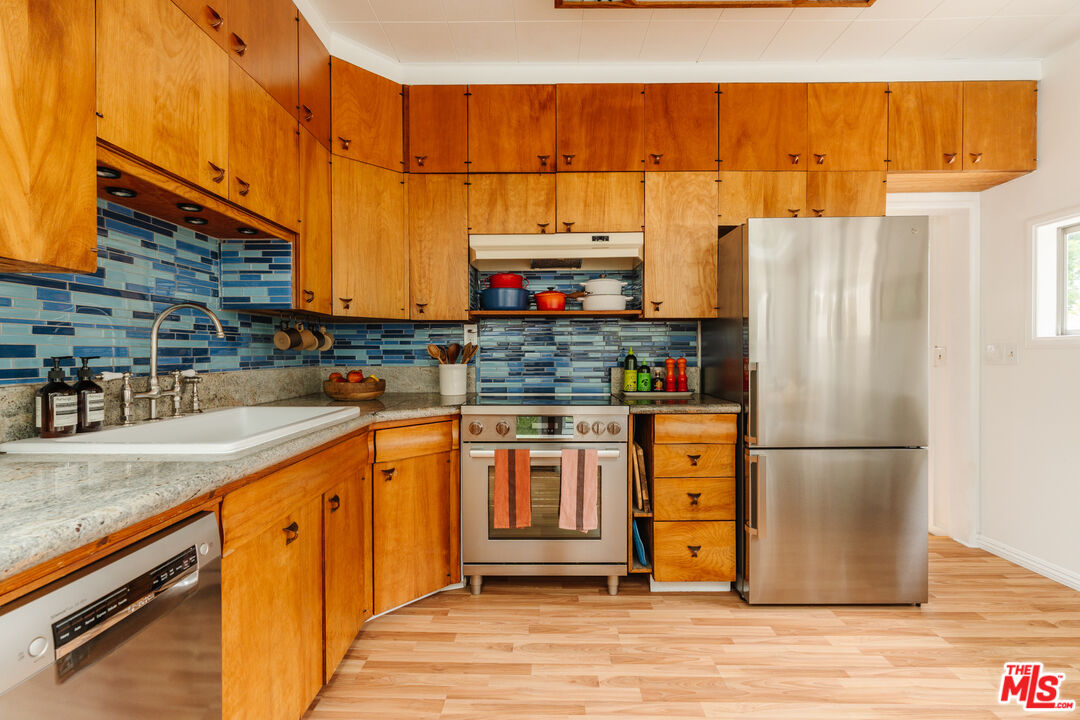 6457 Tokay Road Tujunga, CA 91042 - Photo 25 of 53 a kitchen with stainless steel appliances a refrigerator and a sink