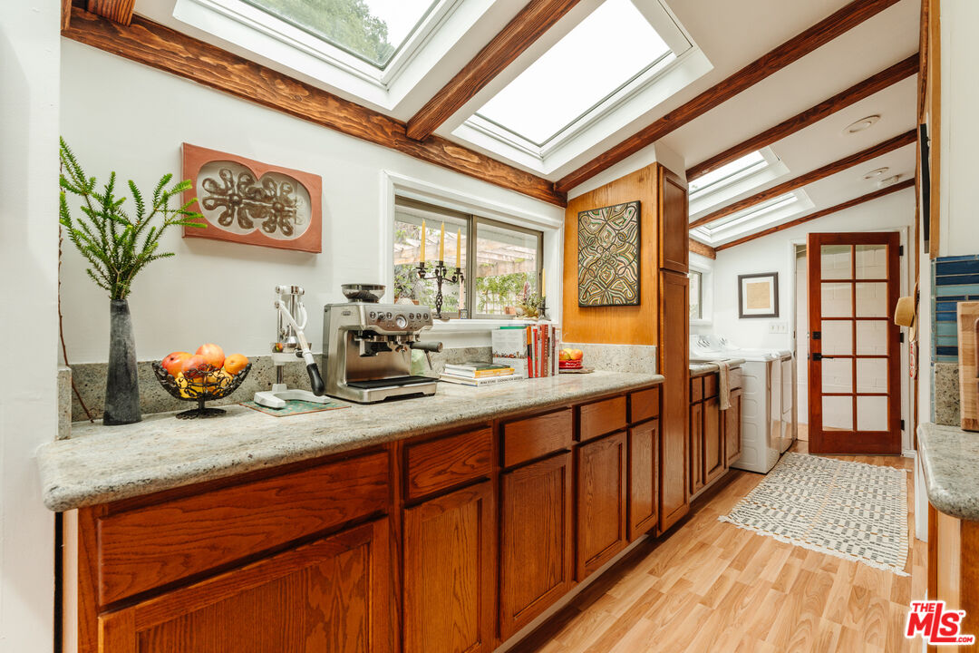 6457 Tokay Road Tujunga, CA 91042 - Photo 28 of 53 a kitchen with stainless steel appliances wooden cabinets a stove and a refrigerator