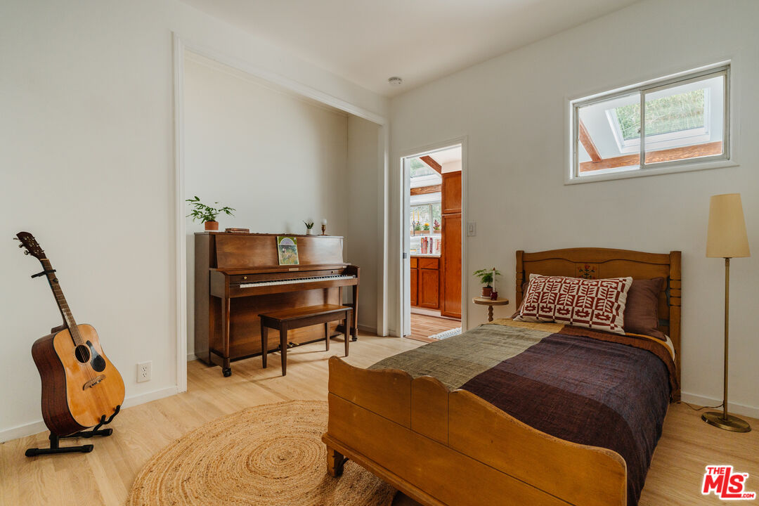 6457 Tokay Road Tujunga, CA 91042 - Photo 30 of 53 a bedroom with a bed and wooden floor