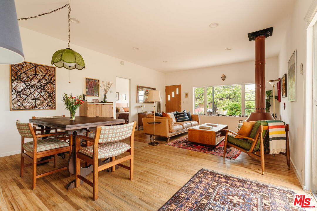 6457 Tokay Road Tujunga, CA 91042 - Photo 8 of 53 a living room with a couch dining table and a floor to ceiling window