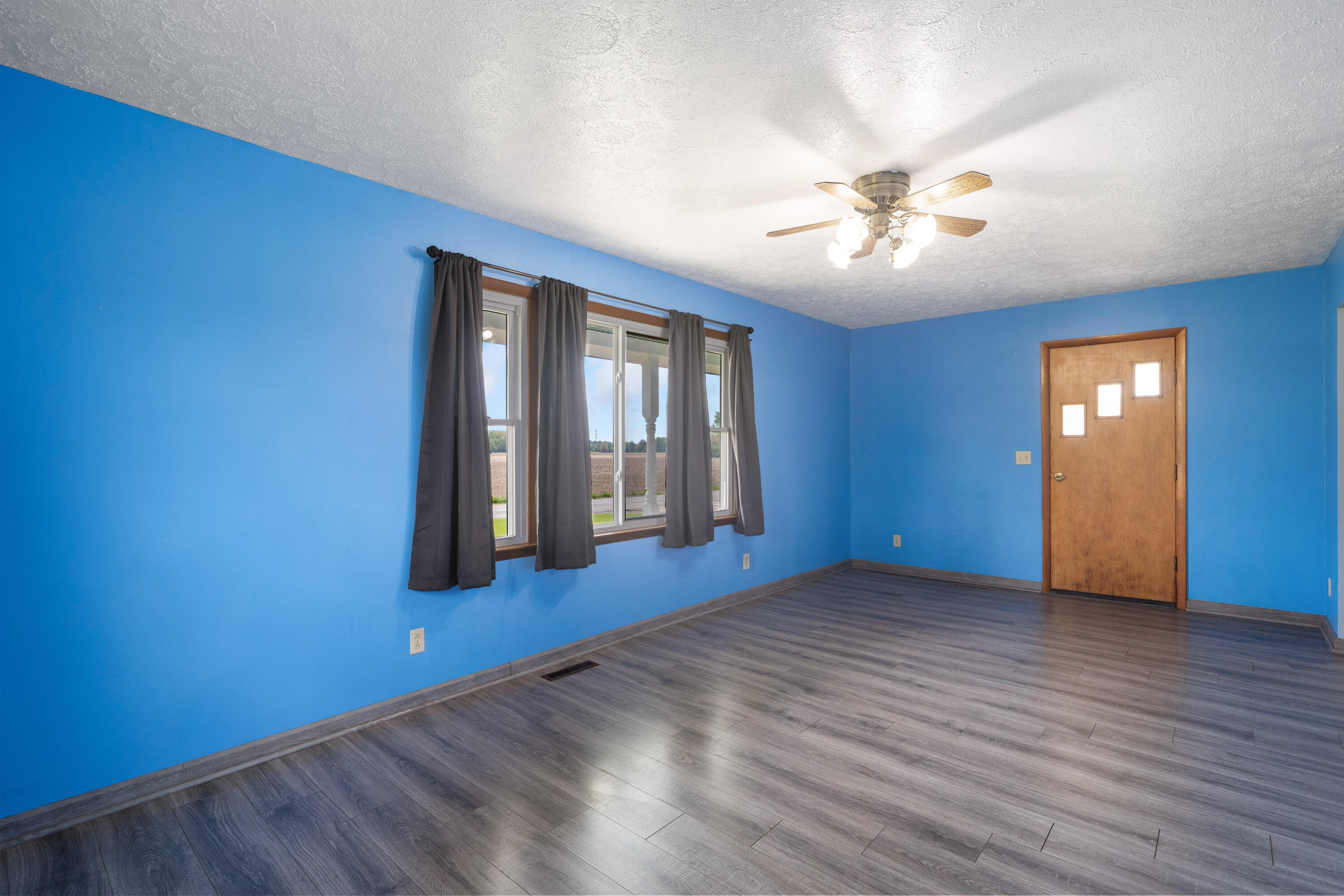 19610 14b Road Culver, IN 46511 - Photo 4 of 23 a view of an empty room with window and wooden floor