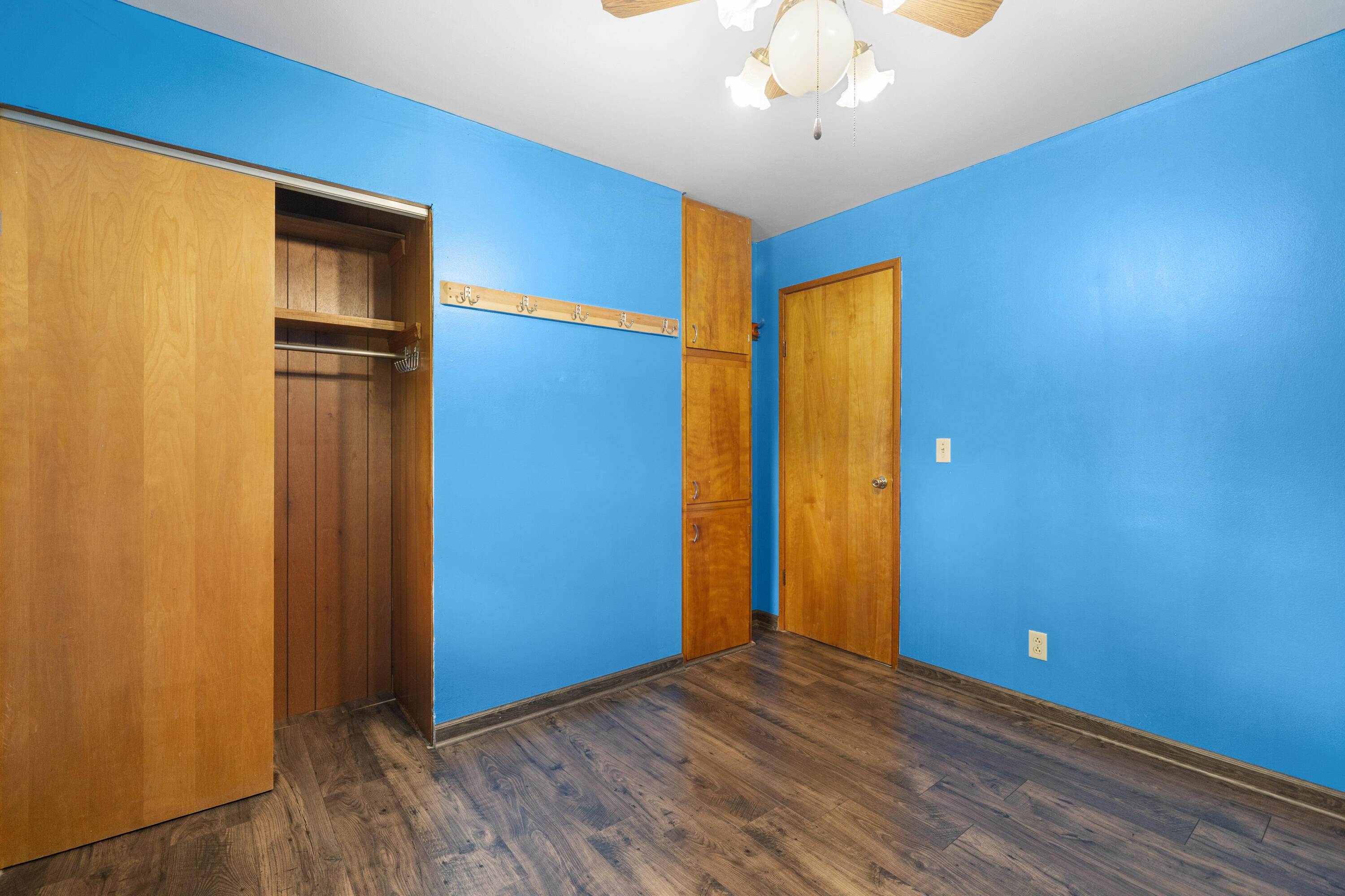 19610 14b Road Culver, IN 46511 - Photo 9 of 23 an empty room with wooden floor and a ceiling fan