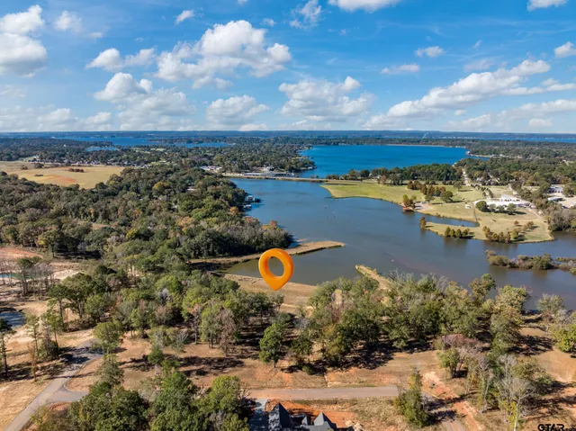 an aerial view of a house with a lake view