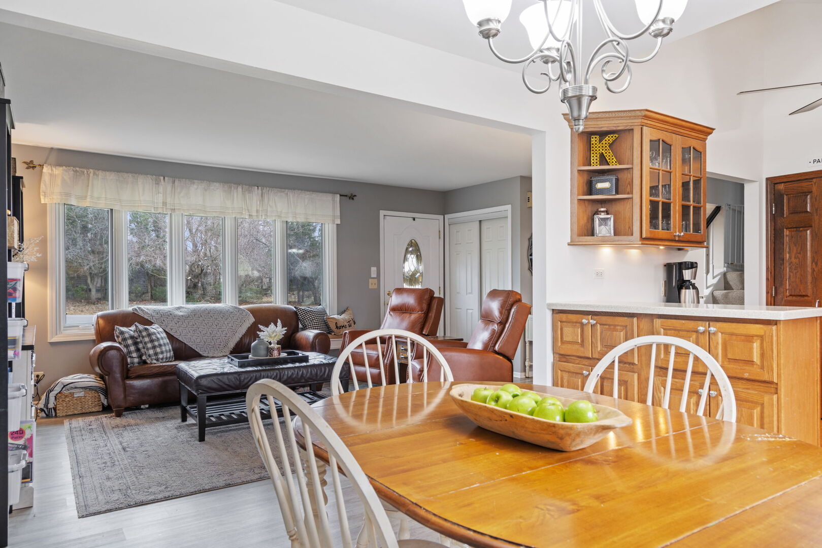 1N264 Darling Street Carol Stream, IL 60188 - Photo 12 of 30 a living room with couches a dining table and chairs with wooden floor