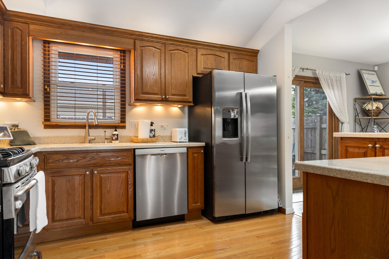 1N264 Darling Street Carol Stream, IL 60188 - Photo 8 of 30 a kitchen with stainless steel appliances granite countertop a refrigerator a sink a stove and island