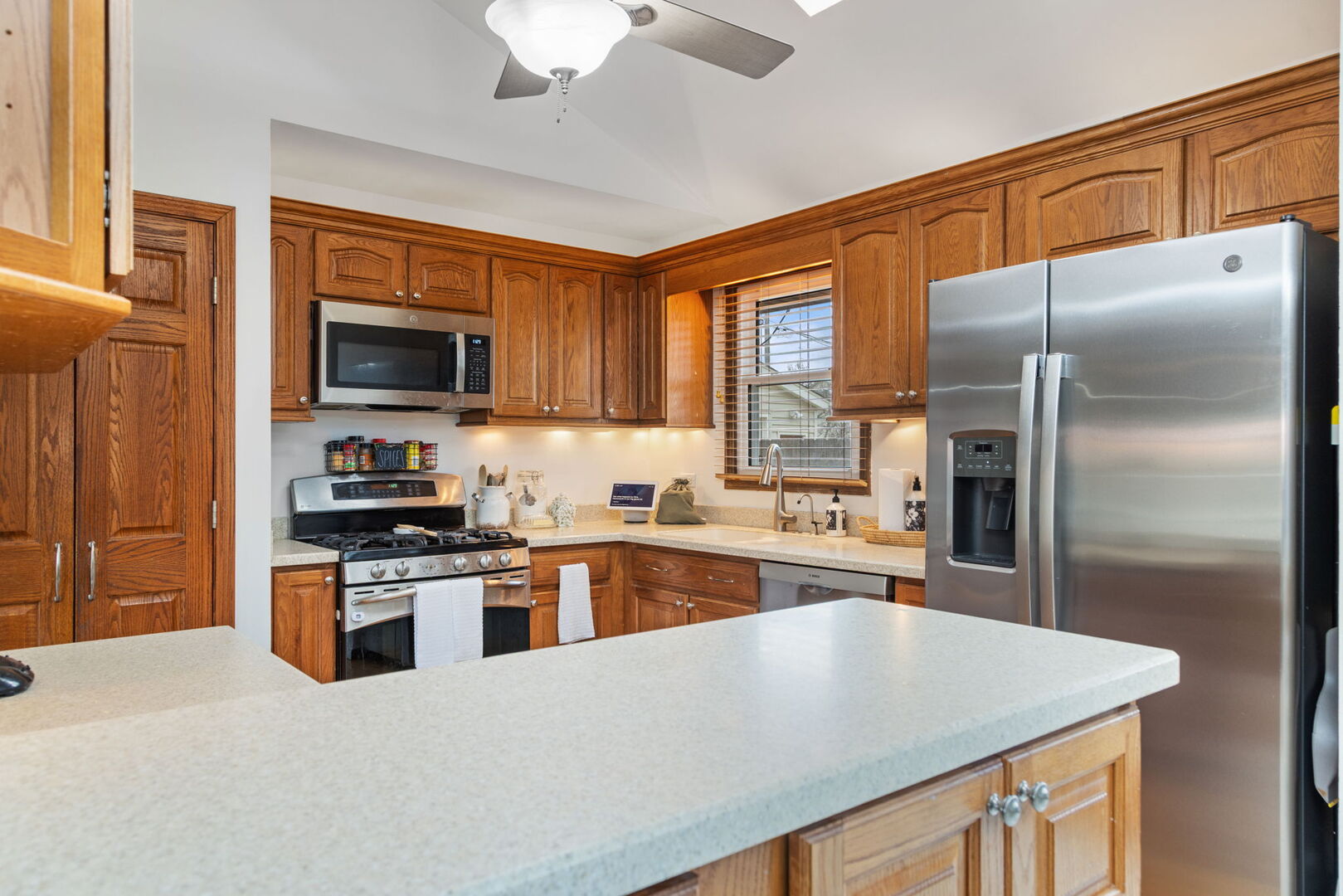 1N264 Darling Street Carol Stream, IL 60188 - Photo 9 of 30 a kitchen with stainless steel appliances granite countertop a refrigerator a stove top oven a sink dishwasher and wooden cabinets with wooden floor