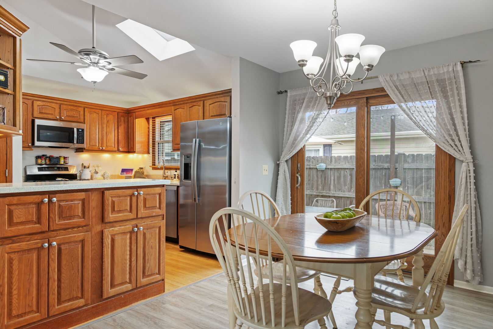 1N264 Darling Street Carol Stream, IL 60188 - Photo 10 of 30 a dining room with wooden floor a chandelier a glass table and chairs