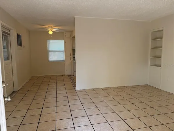 an empty room with white walls and tiles