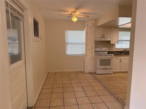 a kitchen with stainless steel appliances a stove a refrigerator a sink a microwave and cabinets