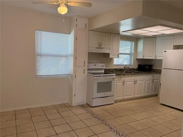 a kitchen with a stove a sink and a refrigerator