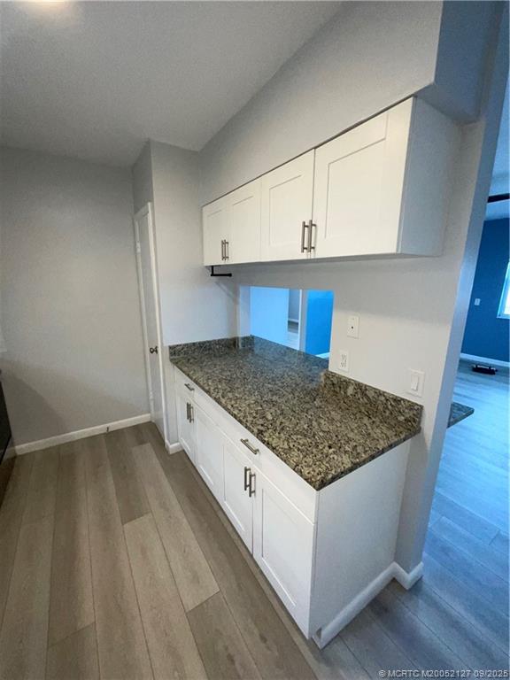 661 Hernando Street, Unit 6 Fort Pierce, FL 34949 - Photo 7 of 12 a kitchen with a stove and cabinets