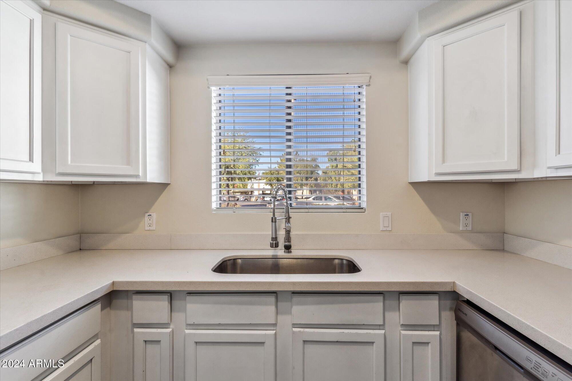 750 East Northern Avenue, Unit 1089 Phoenix, AZ 85020 - Photo 11 of 36 a kitchen with stainless steel appliances granite countertop white cabinets and a sink