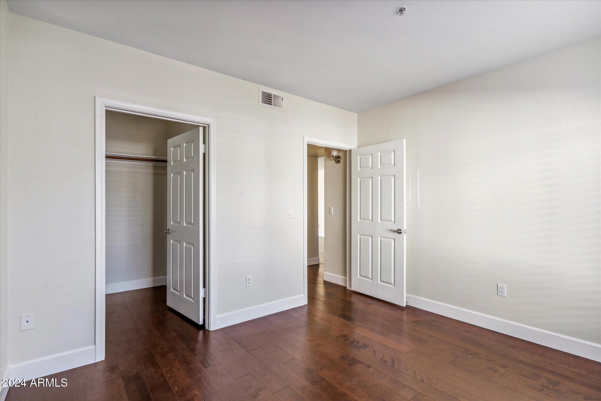 750 East Northern Avenue, Unit 1089 Phoenix, AZ 85020 - Photo 21 of 36 an empty room with wooden floor and closet