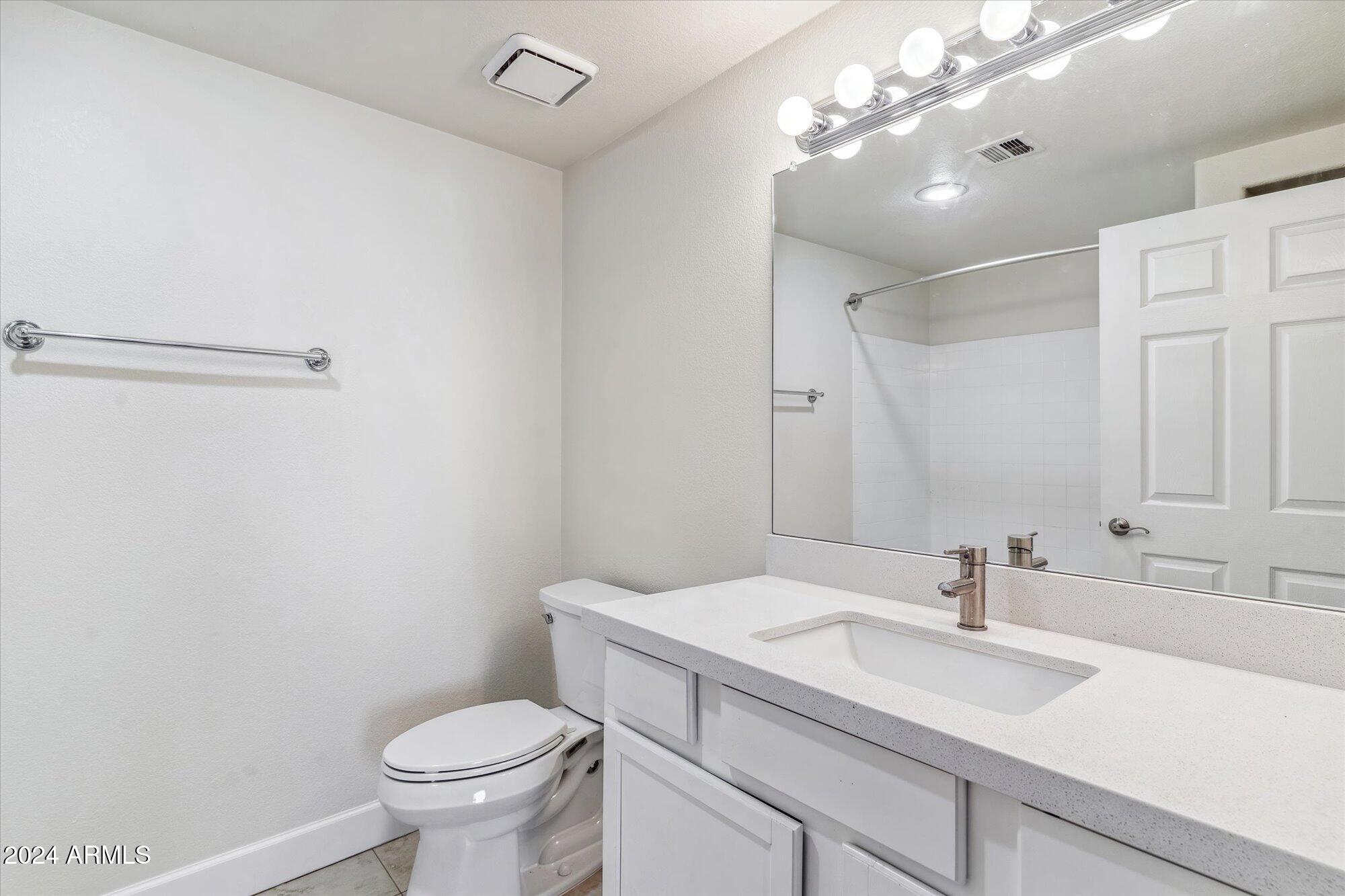 750 East Northern Avenue, Unit 1089 Phoenix, AZ 85020 - Photo 23 of 36 a bathroom with a sink vanity mirror and toilet