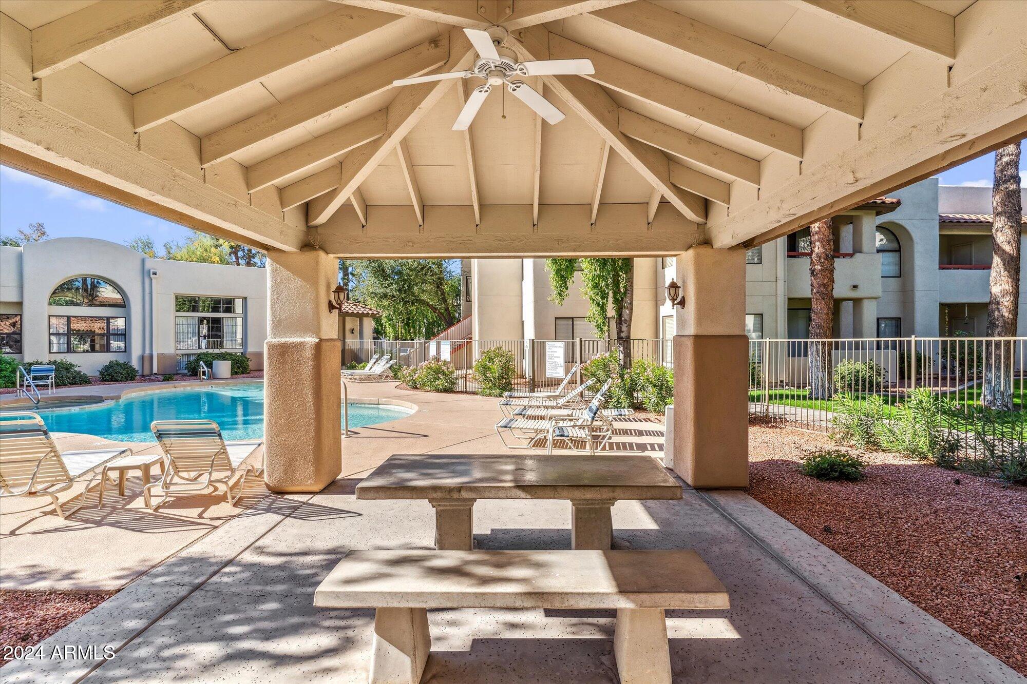 750 East Northern Avenue, Unit 1089 Phoenix, AZ 85020 - Photo 29 of 36 a view of a patio with table and chairs potted plants with wooden floor