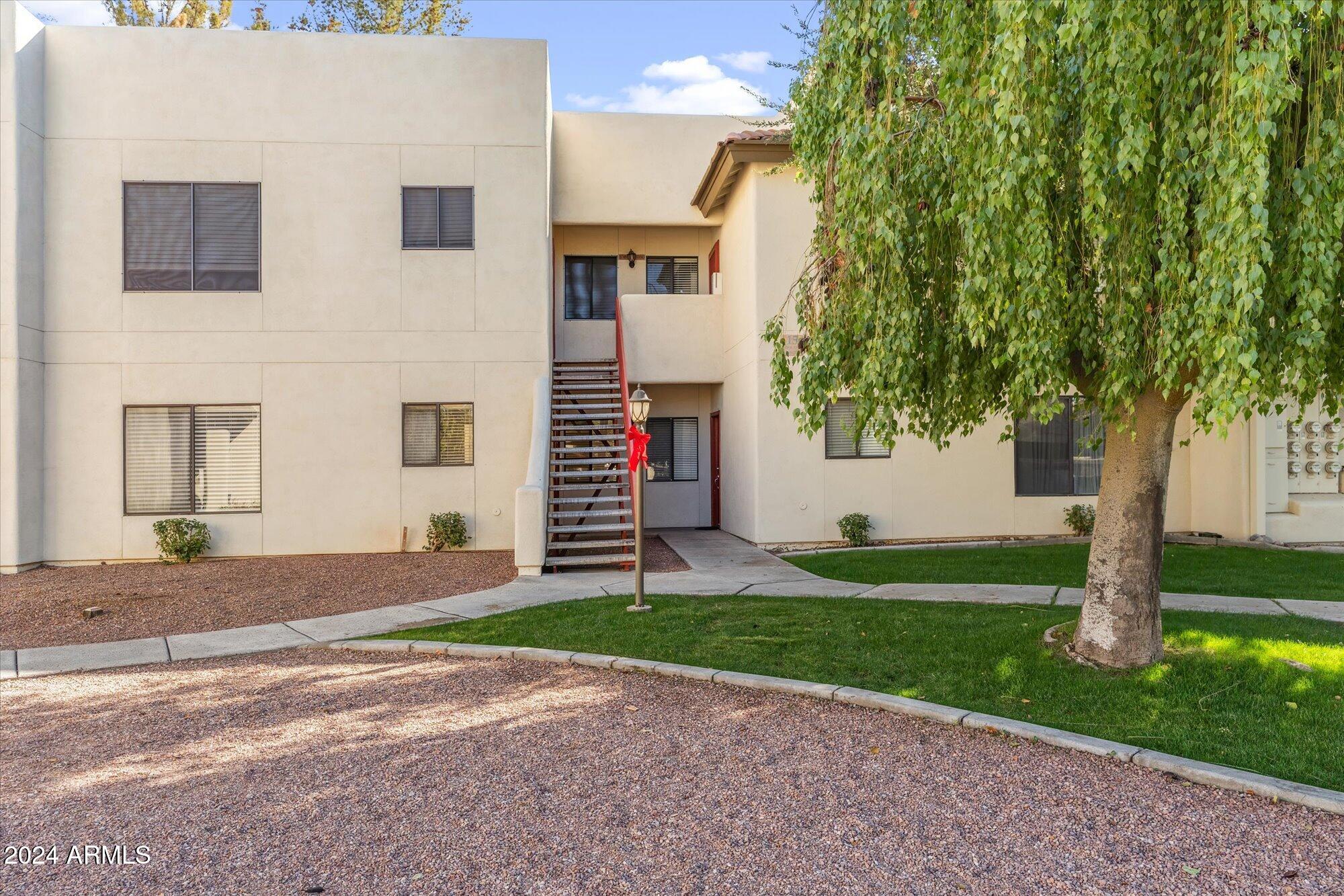 750 East Northern Avenue, Unit 1089 Phoenix, AZ 85020 - Photo 3 of 36 a front view of a house with a yard and garage