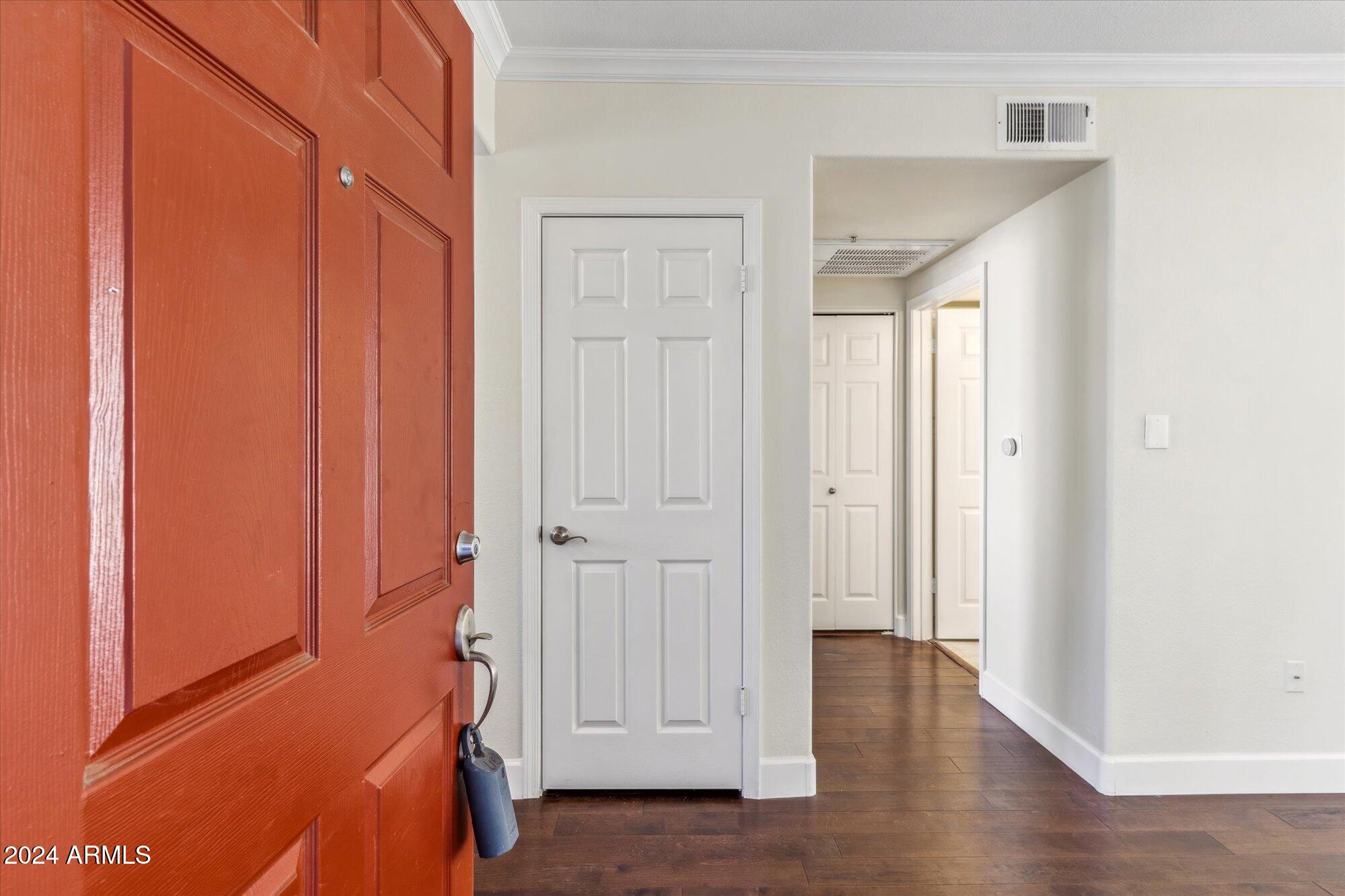 750 East Northern Avenue, Unit 1089 Phoenix, AZ 85020 - Photo 5 of 36 an entryway with wooden floor and cabinet