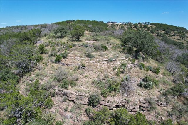a view of a city with lush green forest