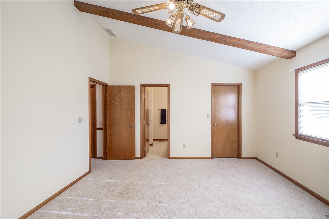 276 South Fairfield Road Bellbrook, OH 45305 - Photo 22 of 38 This primary bedroom features high vaulted ceilings, warm wood accents, and plush carpeting.