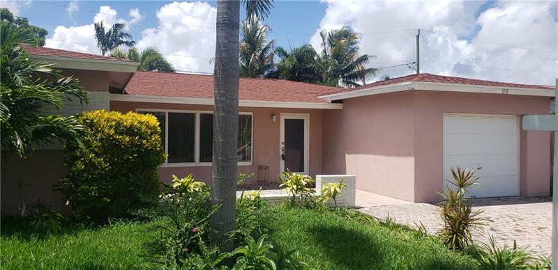 98 Seminole Lane Boca Raton, FL 33487 - Photo 1 of 42 a front view of a house with a yard