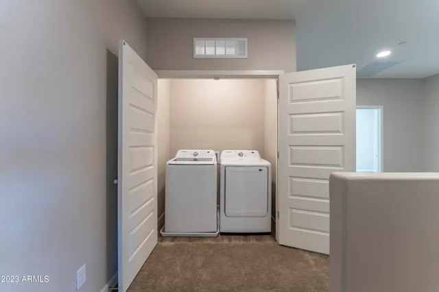 a bathroom with a double vanity sink a mirror and a shower