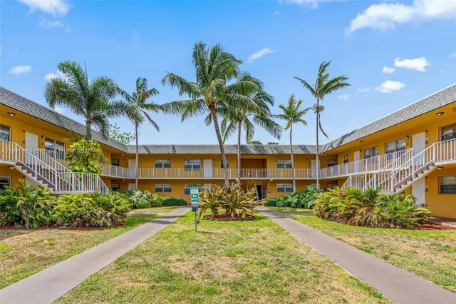 a view of a backyard with a patio and plants