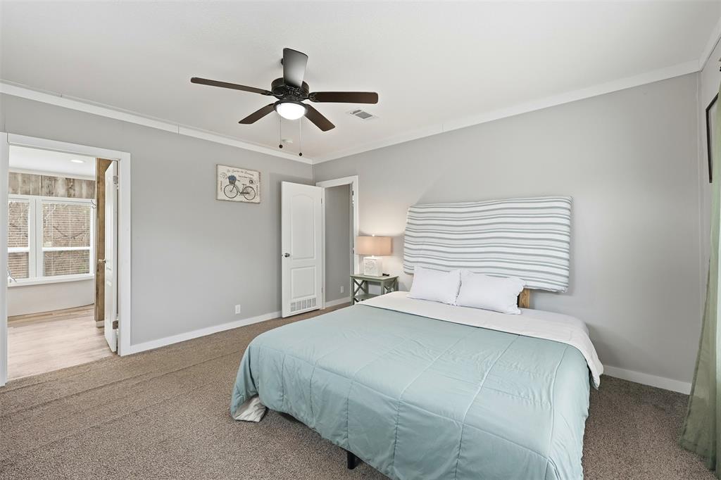 2114 Hickory Street Mabank, TX 75156 - Photo 15 of 31 Primary bedroom with ceiling fan and en suite