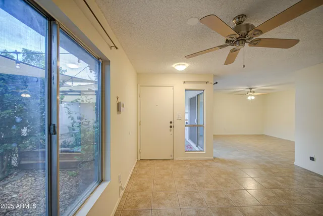 a living room with furniture and a ceiling fan