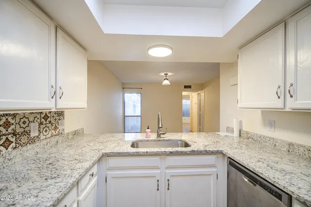 an empty room with fan and windows