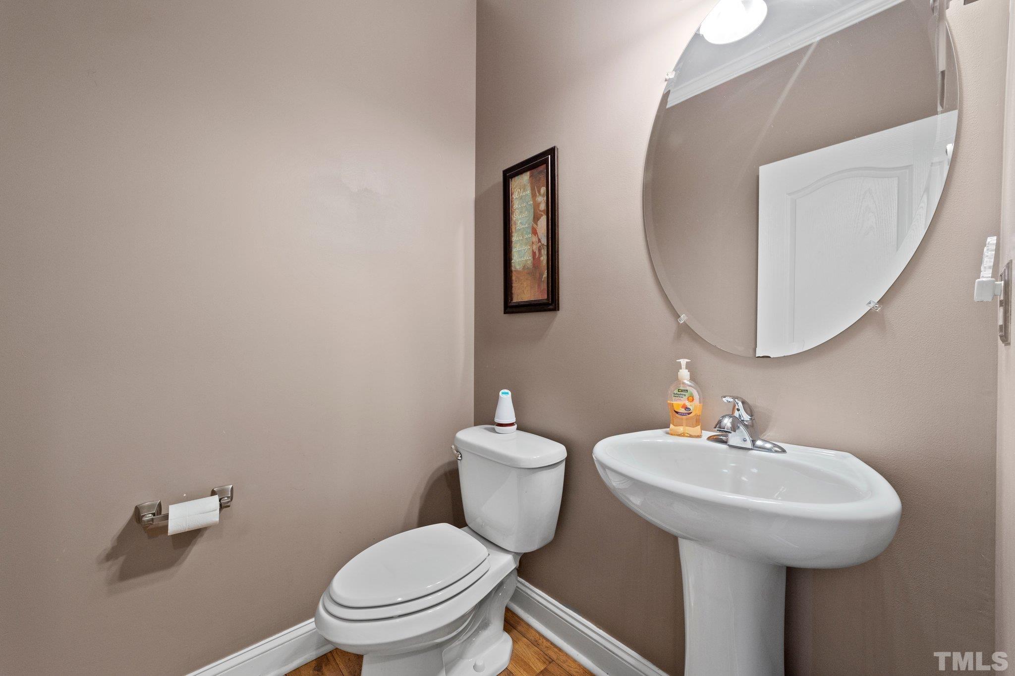 270 Timberland Drive Angier, NC 27501 - Photo 12 of 30 a bathroom with a toilet a sink and mirror